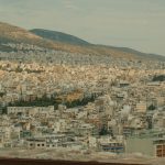 a view of a city with mountains in the background